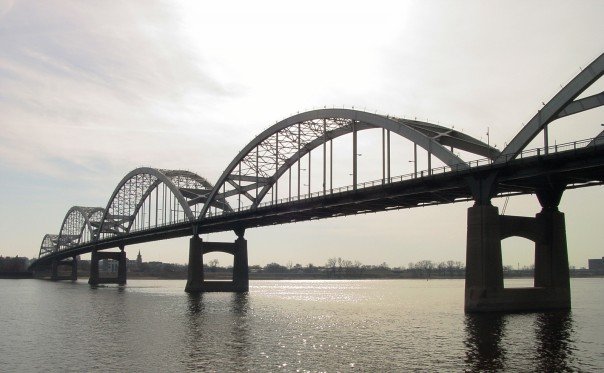 An arch bridge, with 5 arches sits over a river