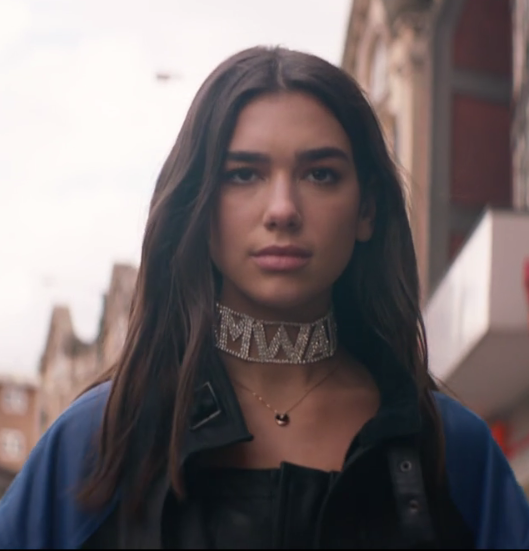 Dua Lipa walking on the street wearing a 