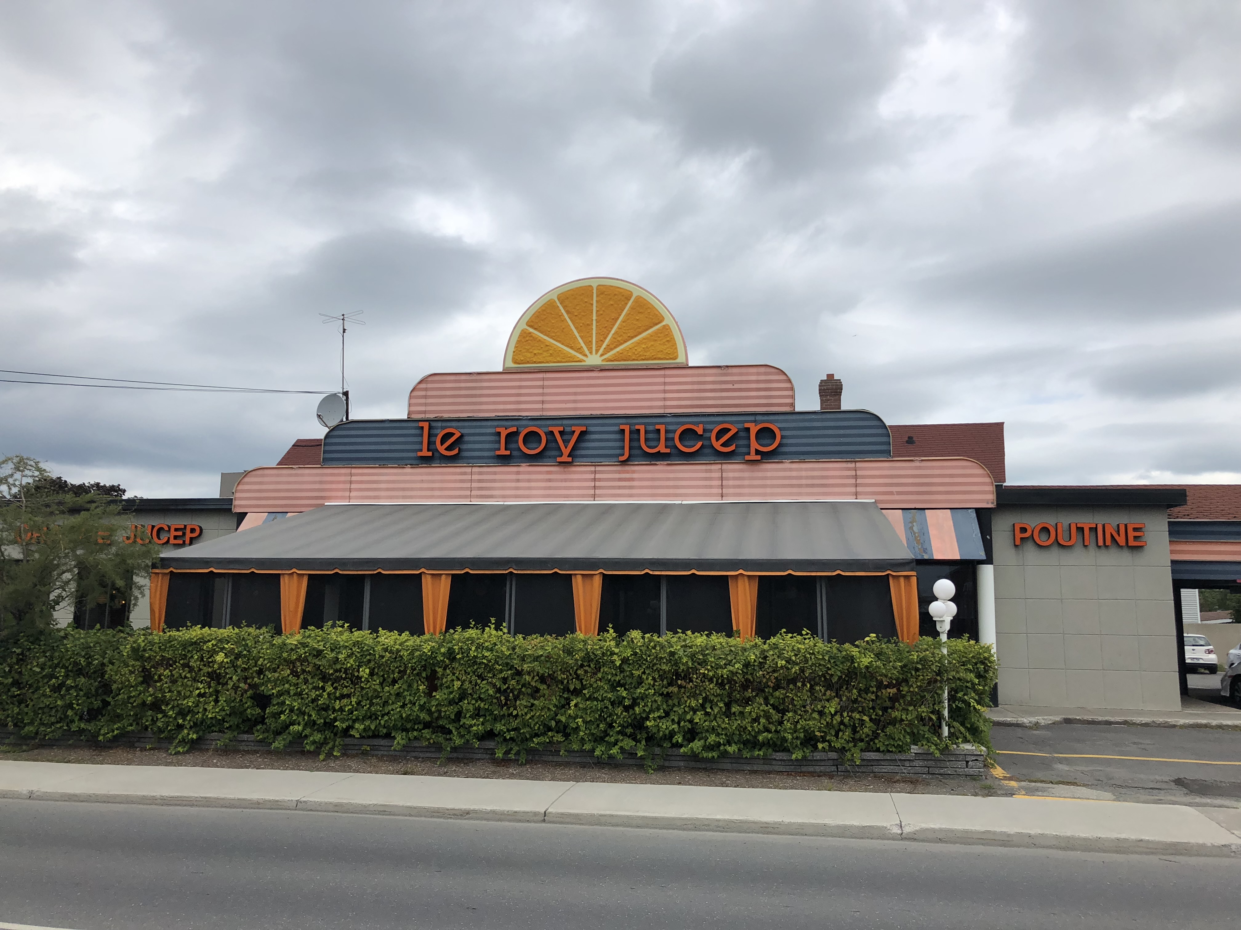 Restaurant with signs on front wall saying 