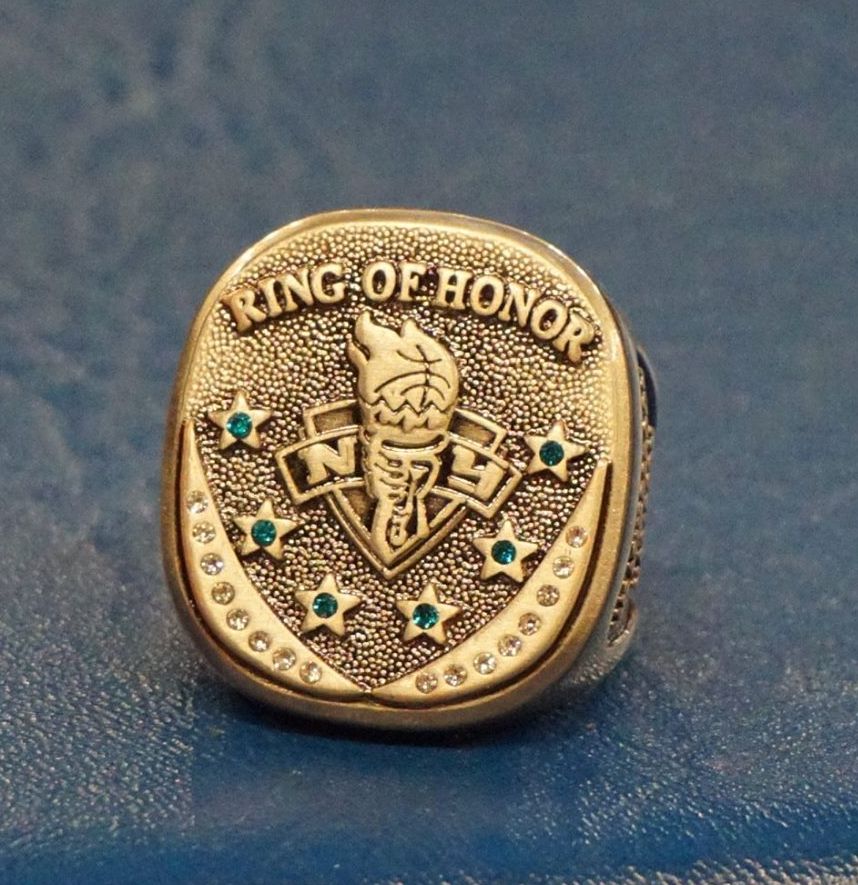 A gold ring with the words quote ring of honor