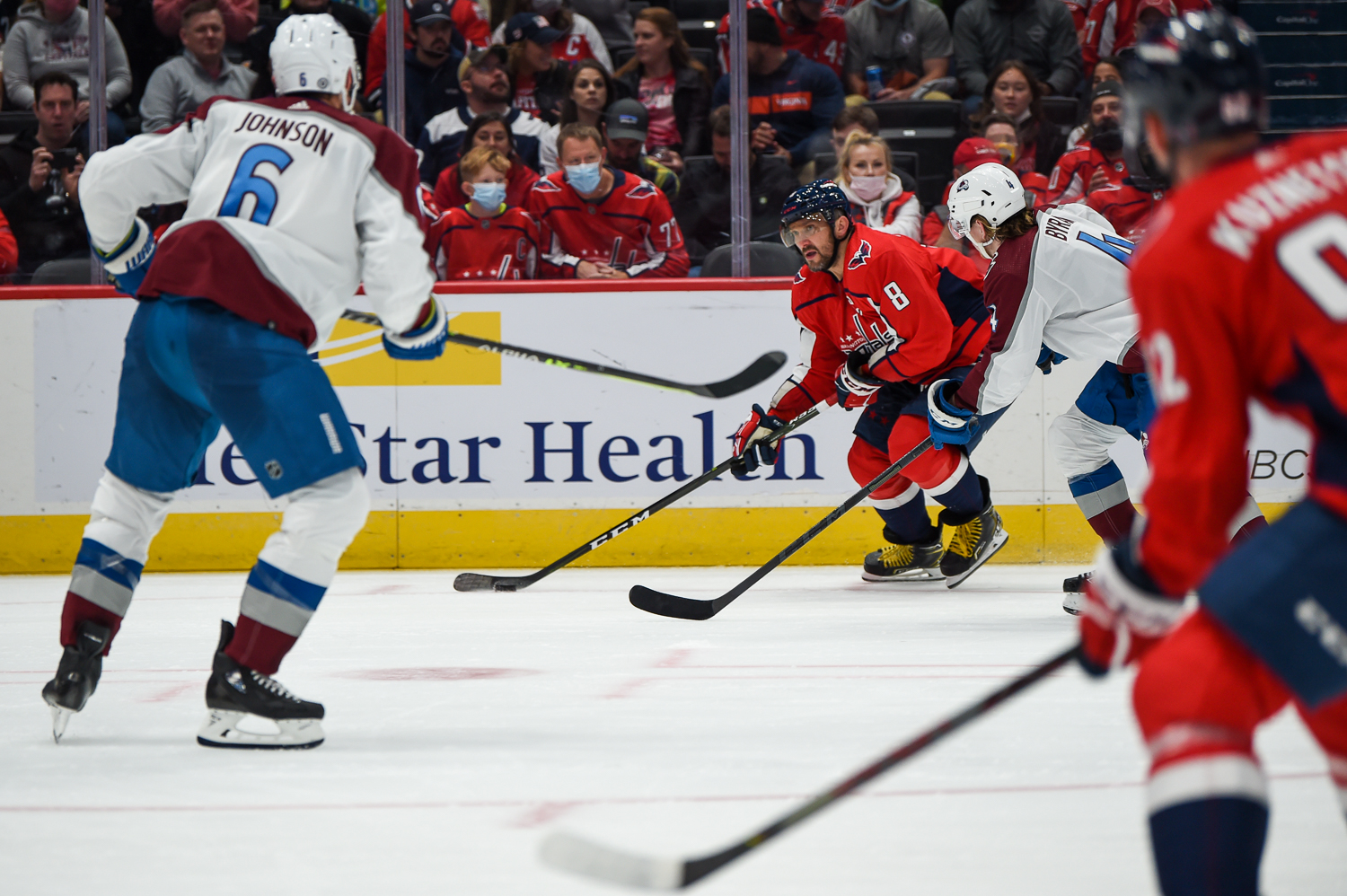 Johnson and Bowen Byram defend against Alexander Ovechkin and Evgeny Kuznetsov in October 2021