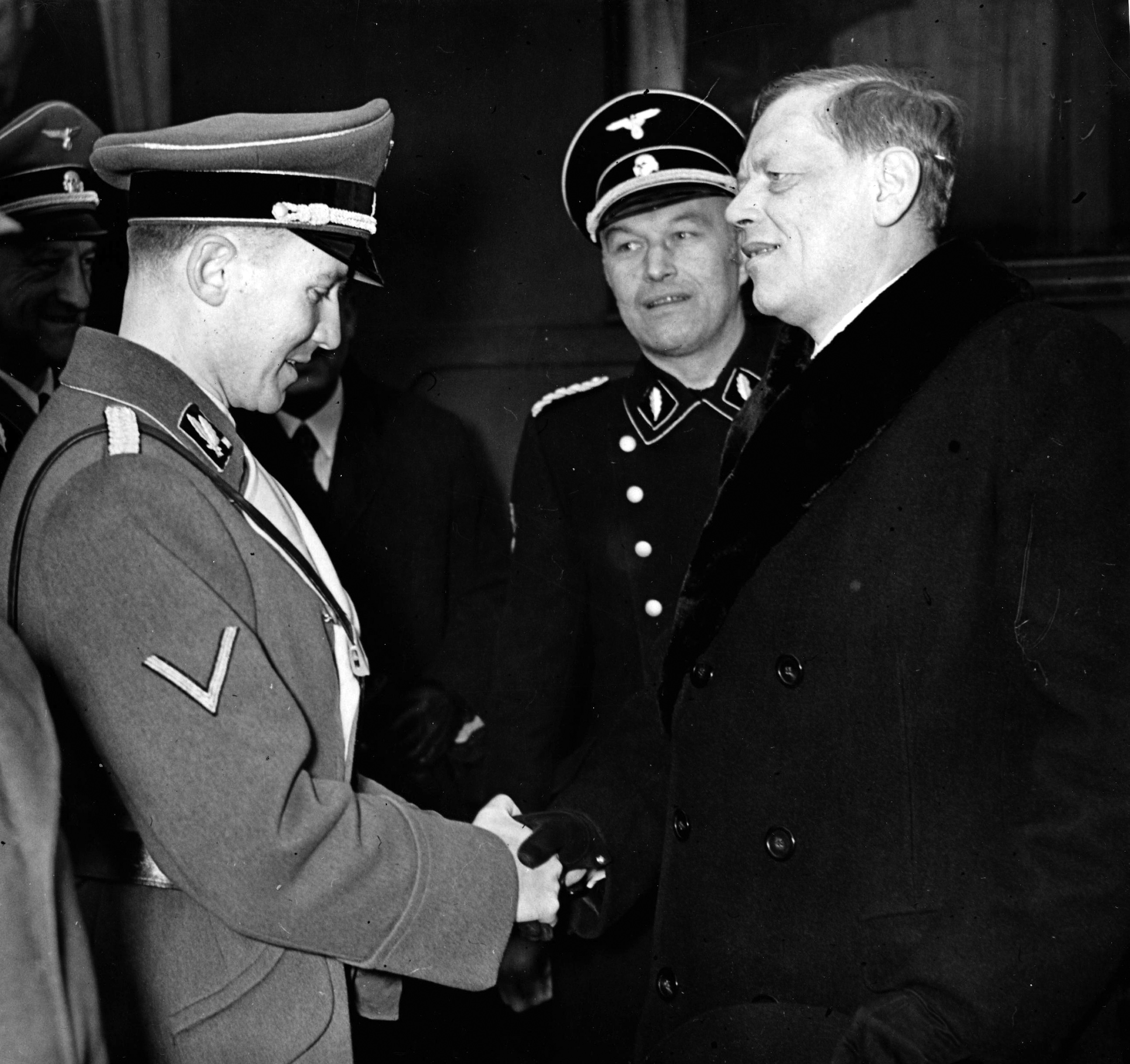 1939년 12월, 나치 친위대 소장 오토 베히터와 악수하는 크나퍼츠부슈