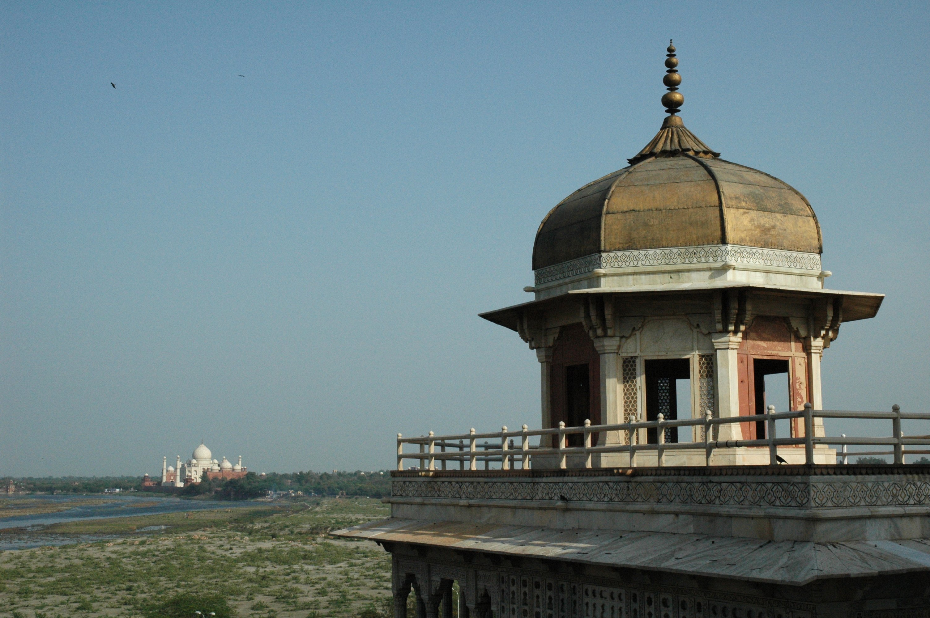 A distant view of the Taj Mahal from the Agra Fort, showcasing Mughal architecture.