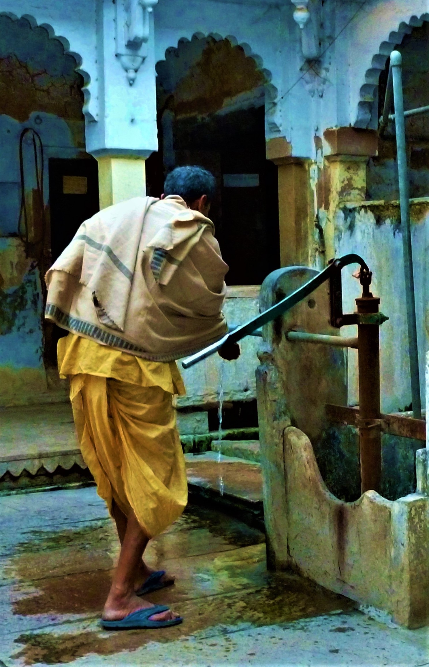 A man in dhoti (a traditional lower garment) and wearing a woollen shawl, in Varanasi, a holy city where traditional attire is common.