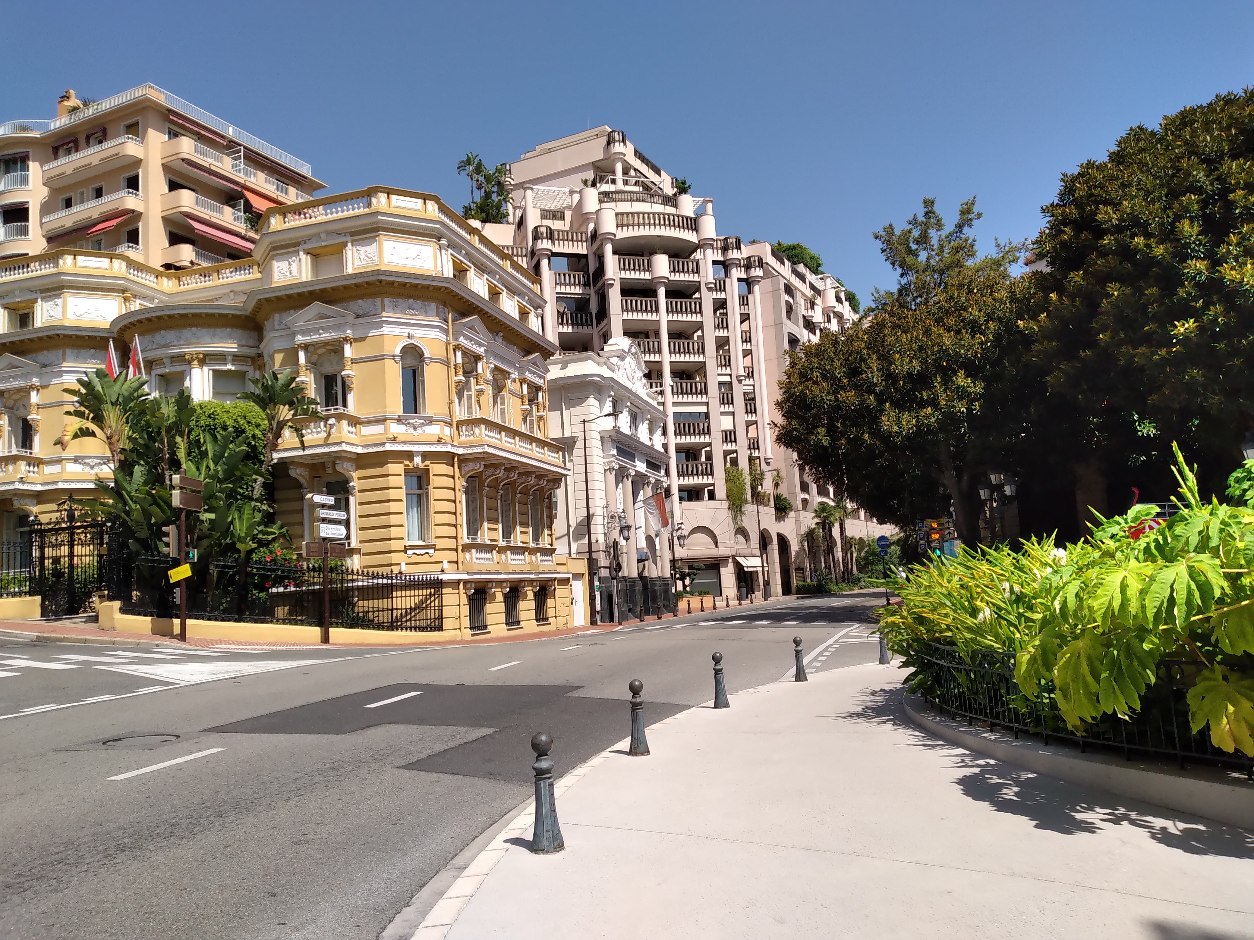 Boulevard des Moulins meeting Avenue Saint-Michel, showcasing Monaco's dense urban and commercial environment.