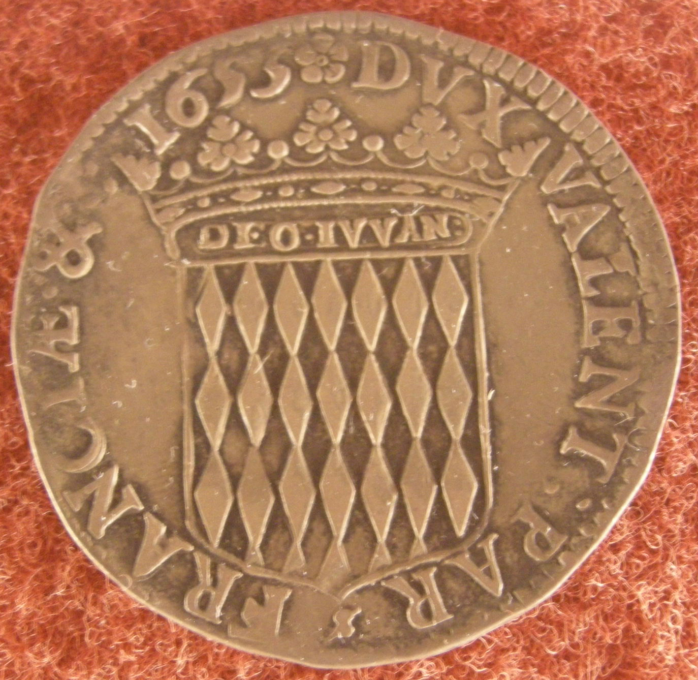 A Genoese coin from 1655. The Republic of Genoa historically influenced Monaco, and early Monégasque currency was often linked to regional standards.
