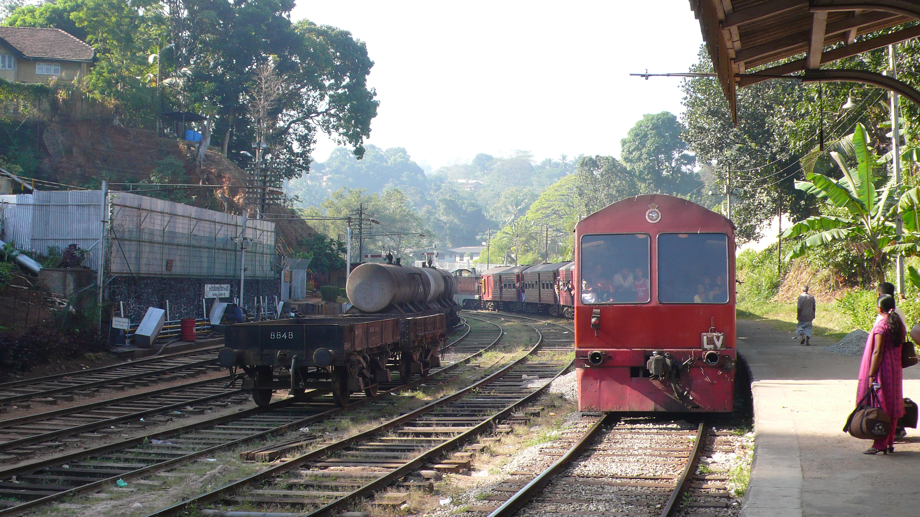 A train arriving at a station in Sri Lanka. The railway network, though aging, provides crucial connectivity, especially for passenger transport and scenic journeys through the hill country.