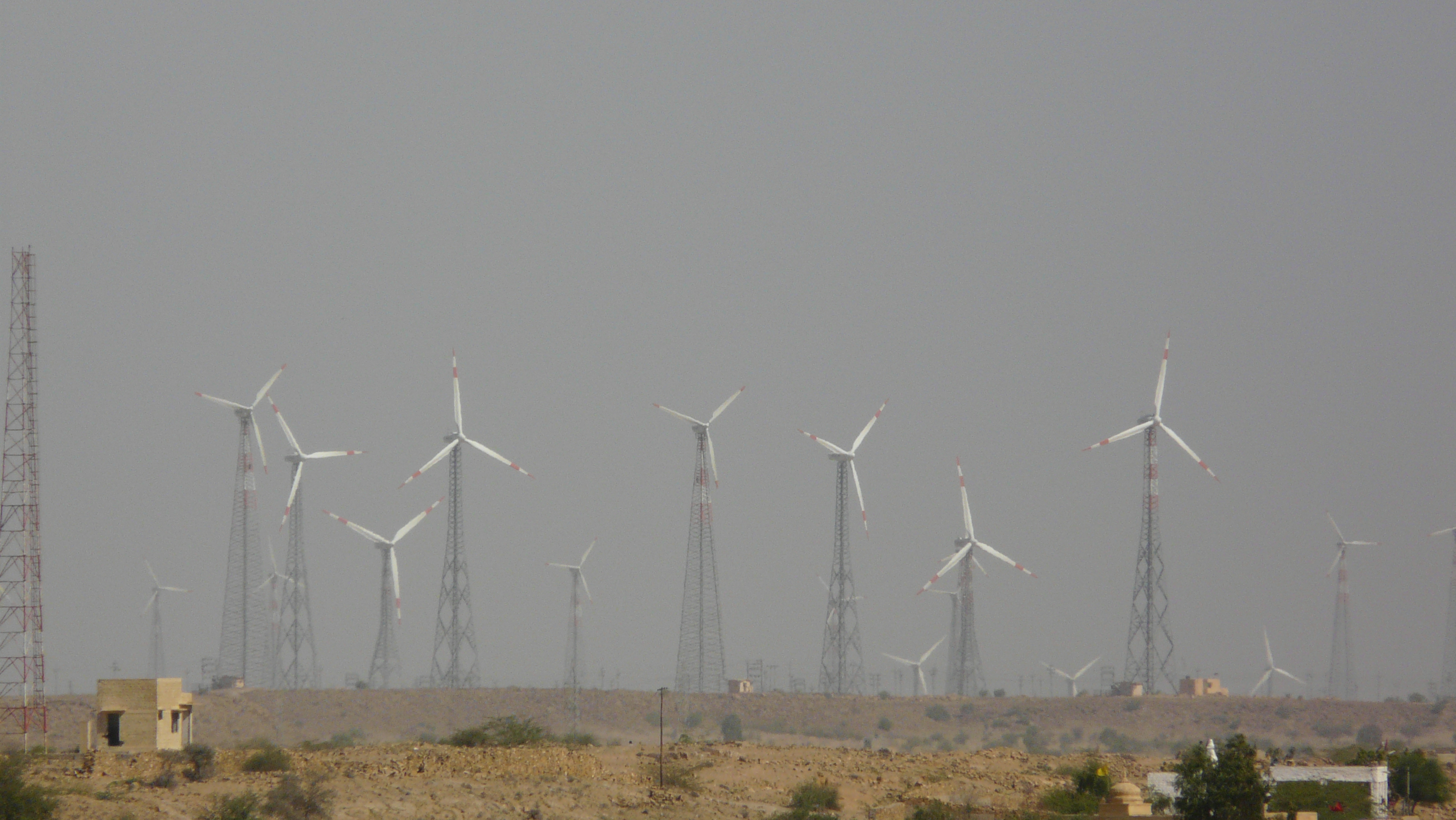 Wind turbines in Jaisalmer, Rajasthan, part of India's growing renewable energy capacity. Transitioning to cleaner energy is crucial for environmental sustainability and mitigating climate change impacts on vulnerable populations.