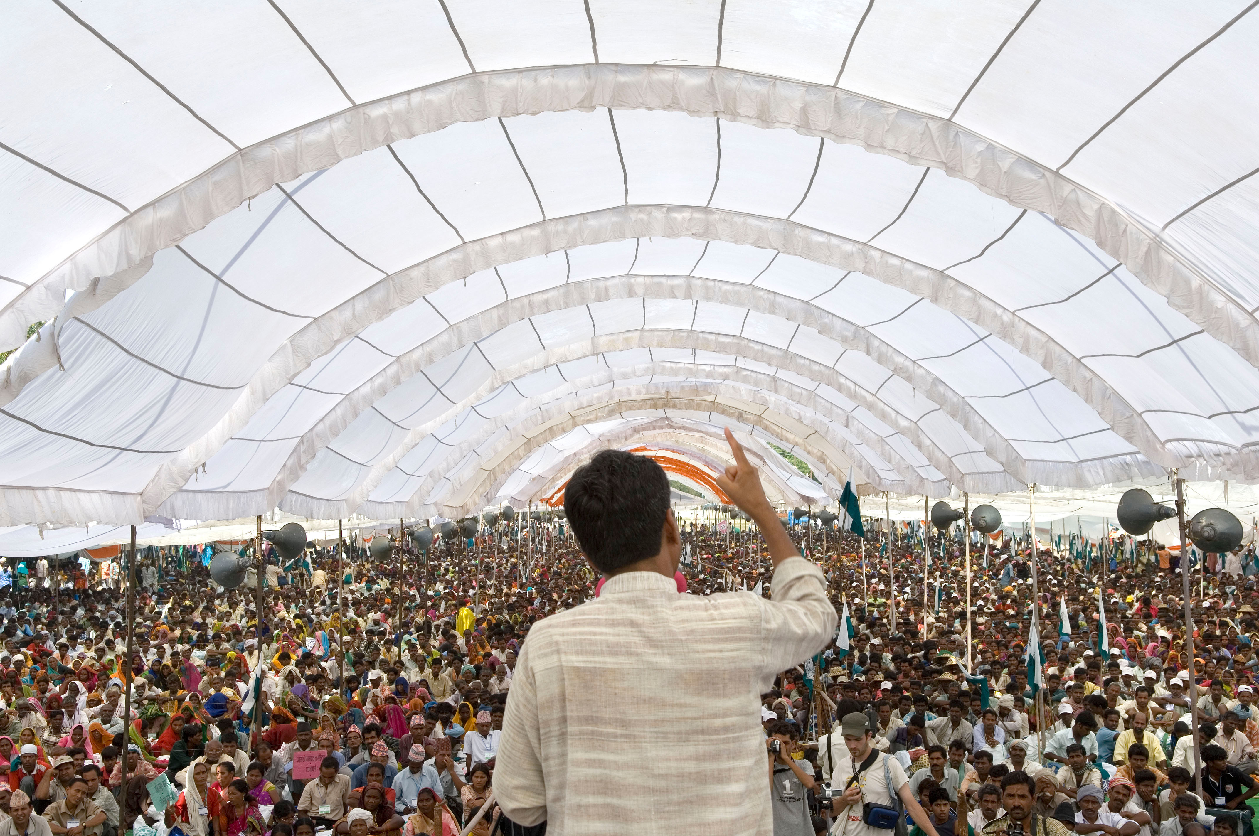 As part of Janadesh 2007, 25,000 pro-land reform landless people in Madhya Pradesh listen to Rajagopal P. V., highlighting democratic participation and activism for social equity and the rights of marginalized communities.