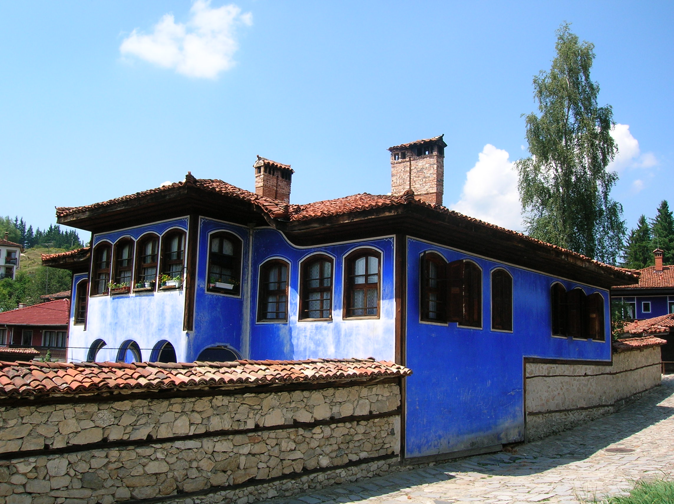 Traditional Bulgarian Revival architecture in Koprivshtitsa, characterized by colorful wooden houses with intricate carvings and spacious verandas.