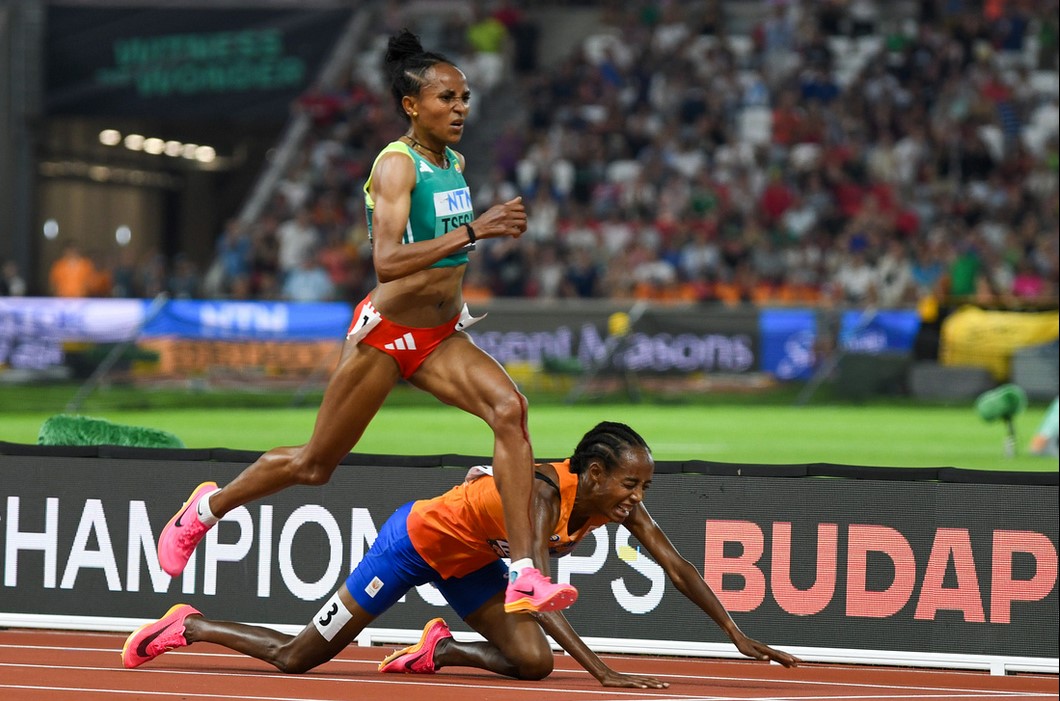 Gudaf Tsegay (left) on her way to winning gold in the 10,000m at the 2023 World Athletics Championships in Budapest, as Sifan Hassan falls.