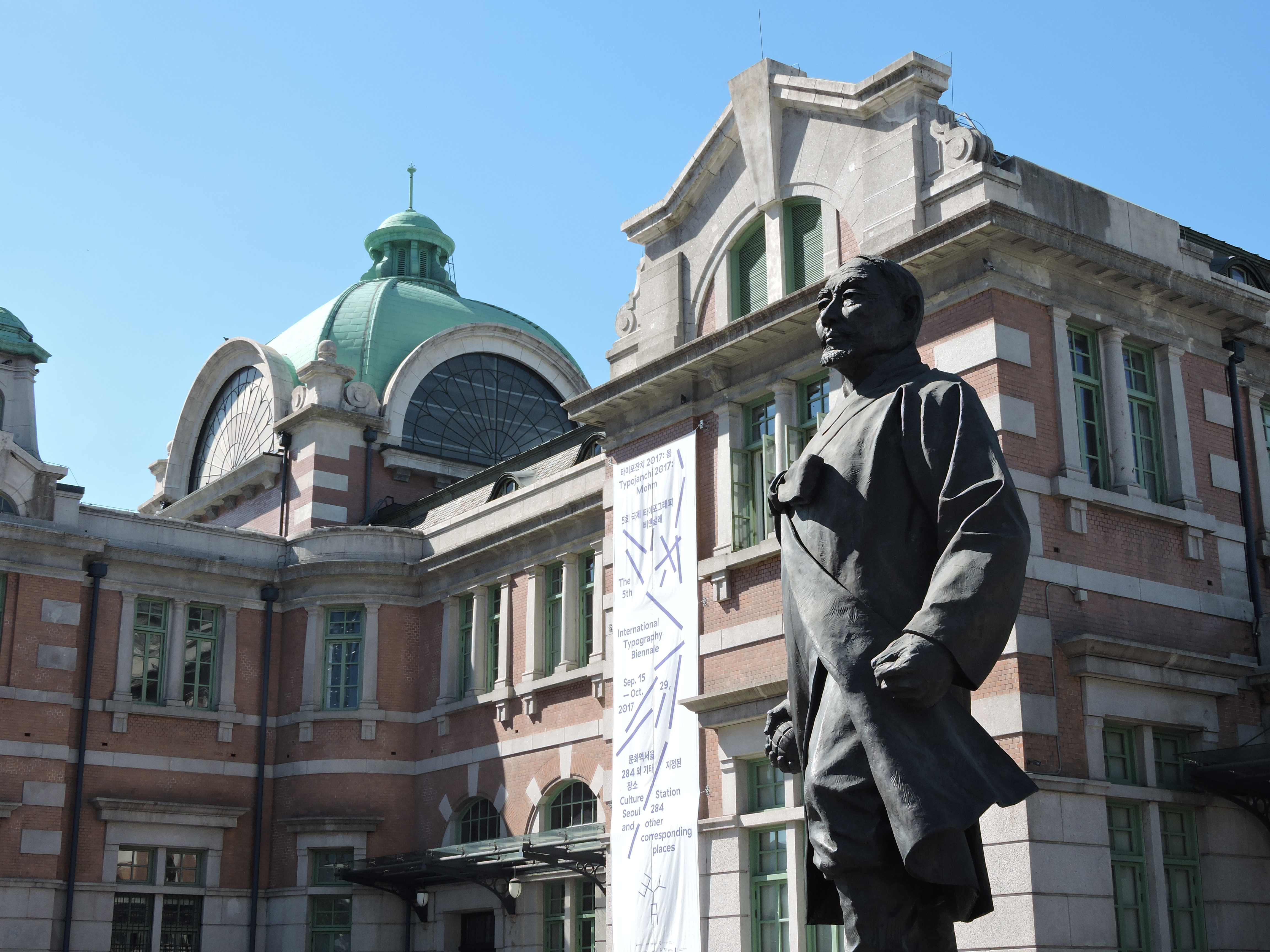 Patung Kang Woo-kyu di depan Stasiun Seoul.