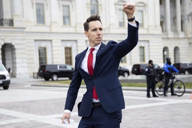 Hawley gives a raised fist salute to pro-Trump protesters outside of the U.S. Capitol on January 6, 2021. Some of these protesters stormed the Capitol building about an hour later.